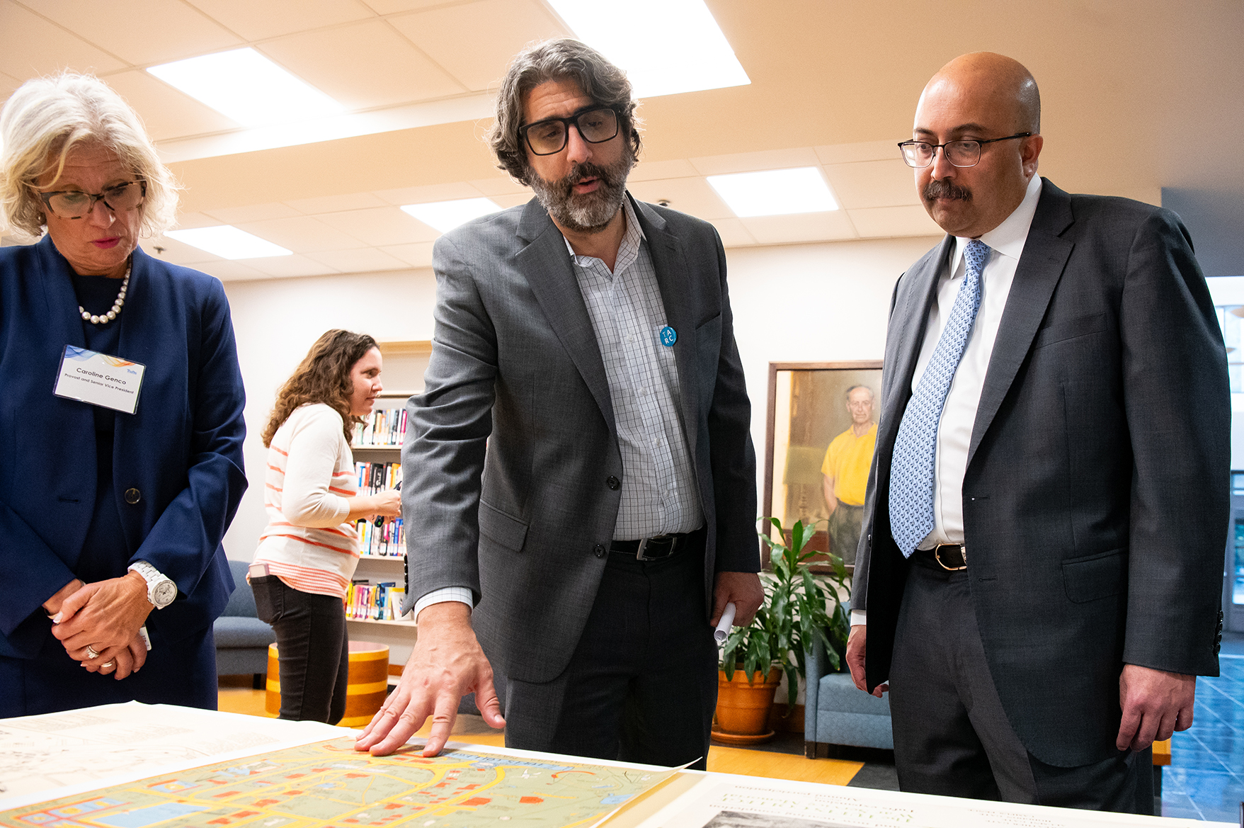 President Sunil Kumar and Provost and Senior Vice President Caroline Genco view archival material with Dan Santamaria, Director of the Tufts Archival Research Center.