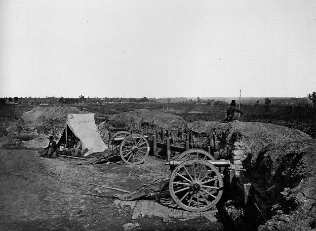 Civil War photo - Union soldiers in canvas tent while a comrade guards a captured Confederate bastion in the defense of Atlanta.