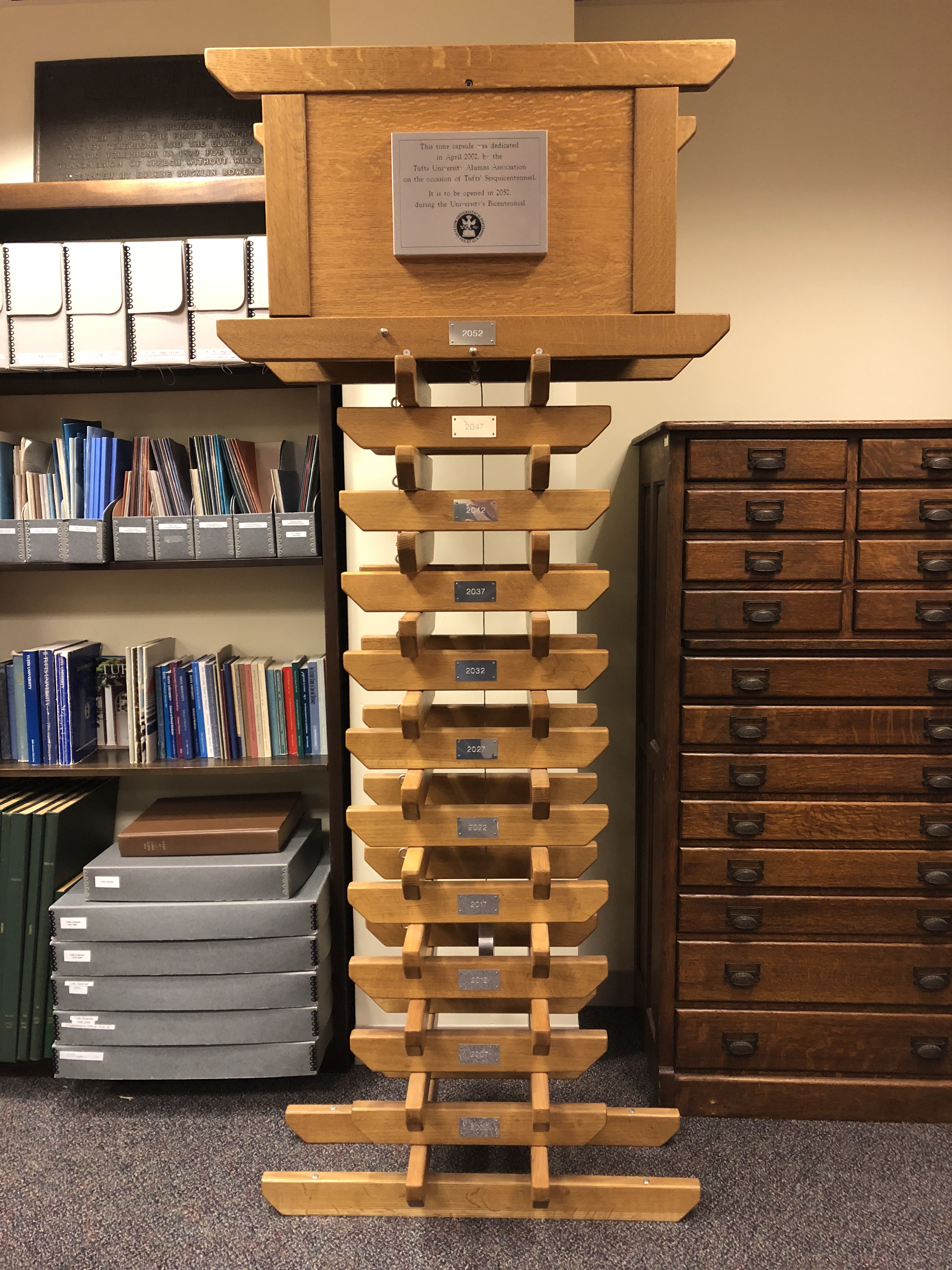 Color photo of wooden structure, the Tufts time capsule.