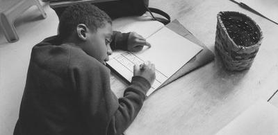 Boy writing, undated, Eliot-Pearson Department of Child Development, http://hdl.handle.net/10427/3462 records.
