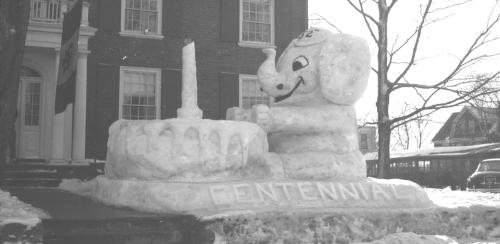 Snow sculpture depicting Jumbo in front of a birthday cake.