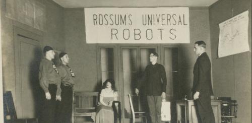 Black and white photo of five students onstage acting in a play.