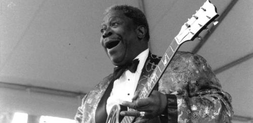 Black and white image of B.B. King onstage with a guitar.