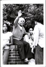 Black and white photograph of students relaxing outside of Carpenter House, the home of the Afro-American Center.