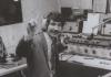 Black and white photo of a WMFO radio host making a peace sign at the camera.